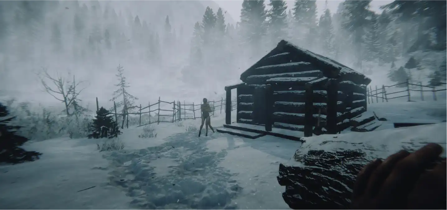 log cabin with a figure outside in the snow
