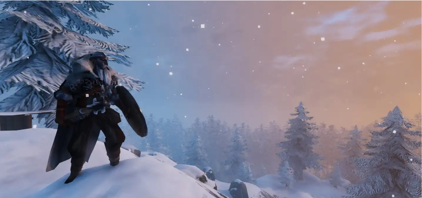 a valheim character looking over snow covered trees